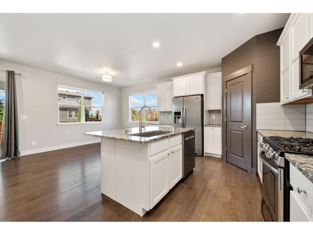 Property Photo 7 Open concept kitchen with pantry, lots of cabinet space and gas stove.