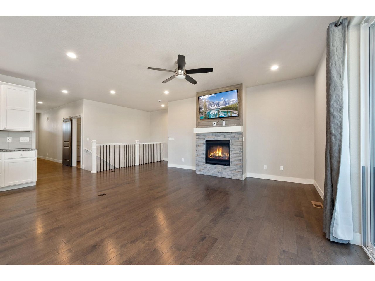 Property Photo 12 Great room with gas fireplace, connects to the primary bedroom and stairs to the finished basement.