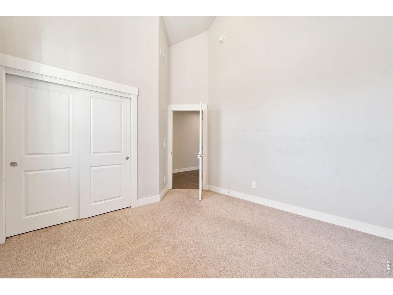 Property Photo 19 Second bedroom at the front of the home leads out to the main hallway of the home.