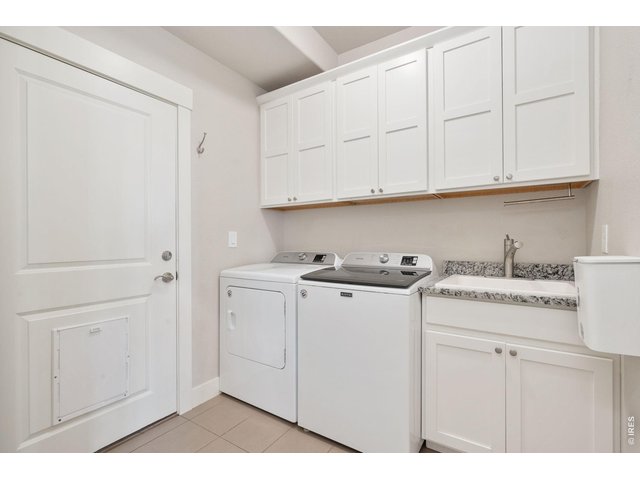 Property Photo 28 Laundry room with wash out sink and leads out to the garage.