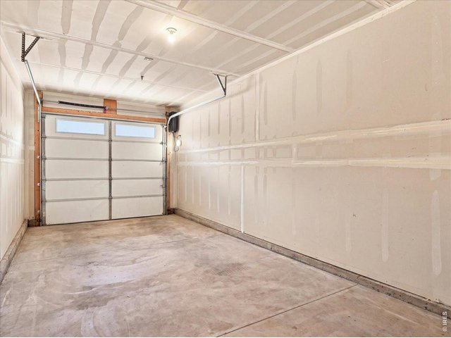 Property Photo 29 Oversized garage with smart garage door opener and you don't have to take a step outside to access this space!