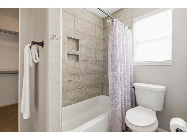 Property Photo 23 Primary Bath with new tile surround and tile floors!