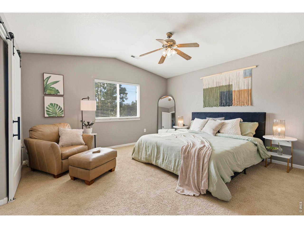 Property Photo 17 Primary suite with slider door and vaulted ceilings