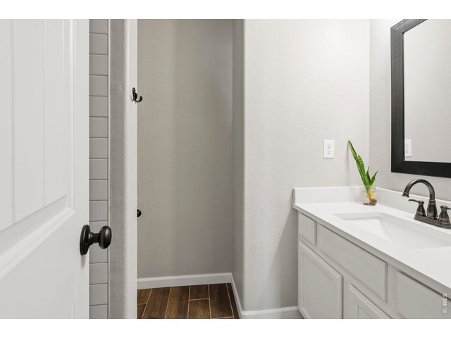 Property Photo 26 Guest bath boasting new tile floors, quartz countertops & fixtures!