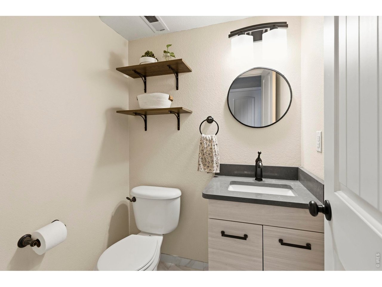 Property Photo 16 Main level powder bath boasting new vanity and granite top