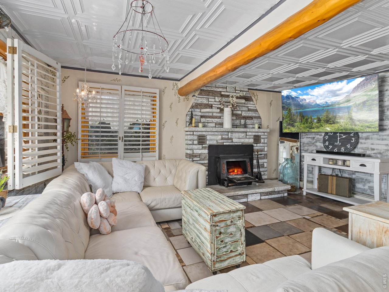 Property Photo 4 Spacious living room with a wood burning stove.