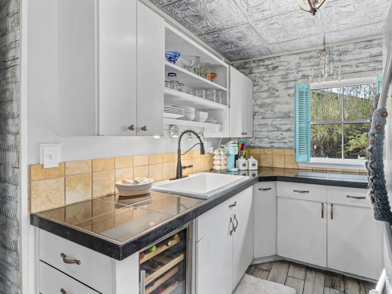 Property Photo 10 Kitchen with newer updated sink, refrigerator, and stove.