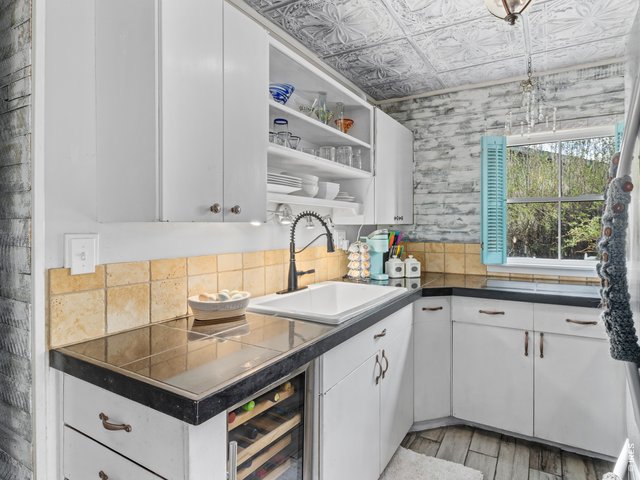 Property Photo 10 Kitchen with newer updated sink, refrigerator, and stove.