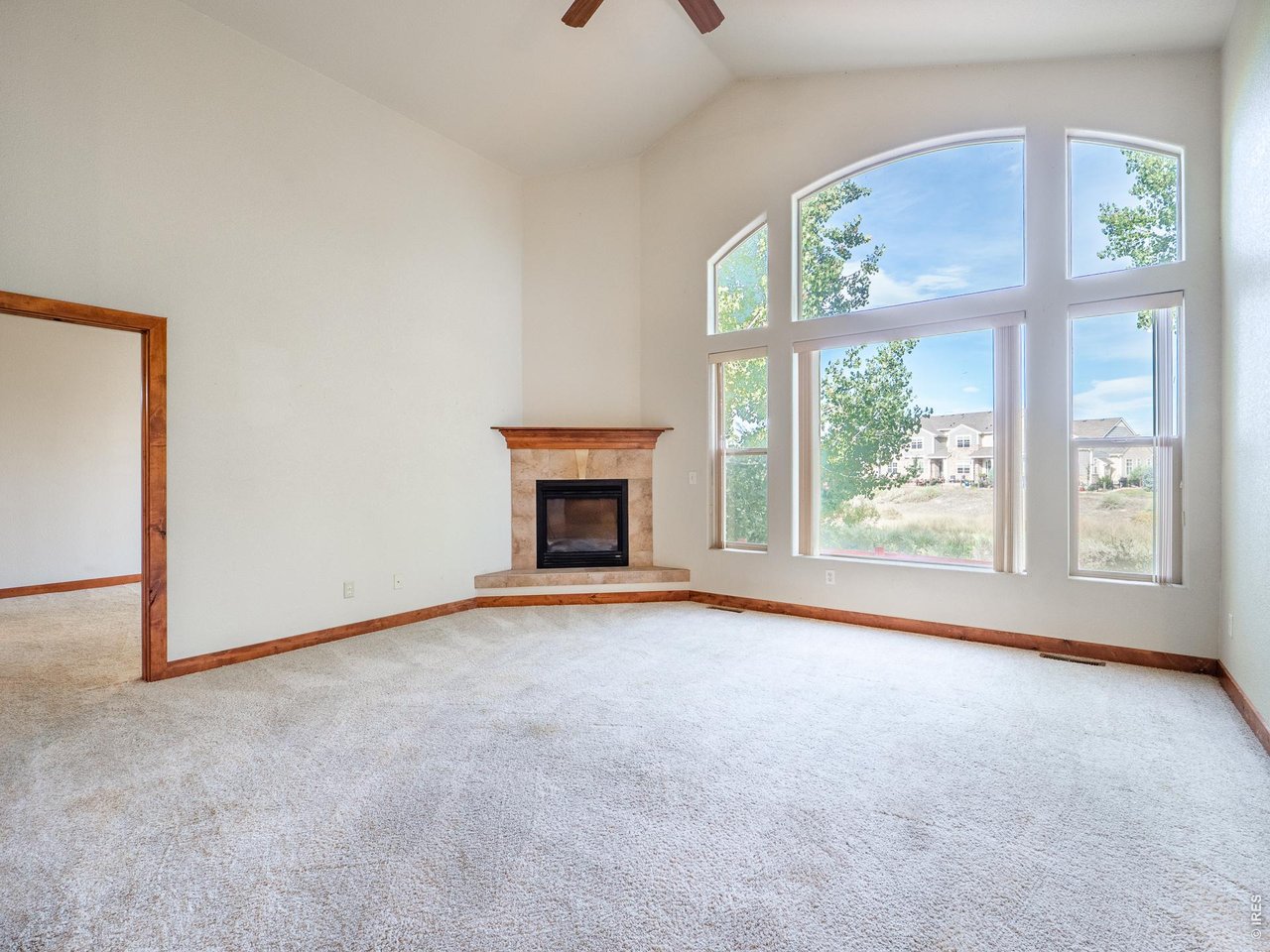 Property Photo 31 Living room with vaulted ceilings and large windows overseeing private open space