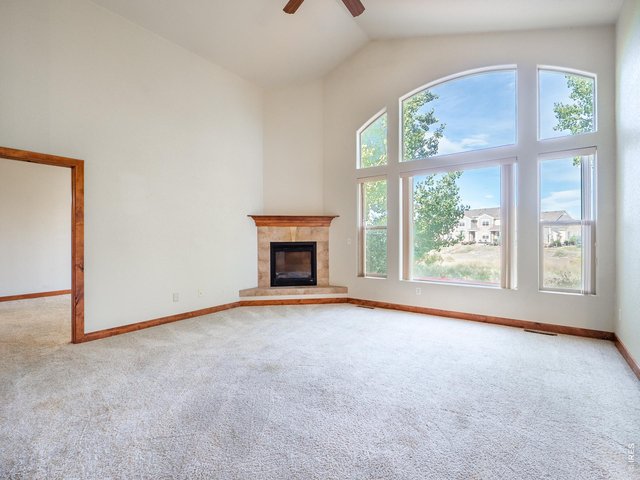 Property Photo 31 Living room with vaulted ceilings and large windows overseeing private open space