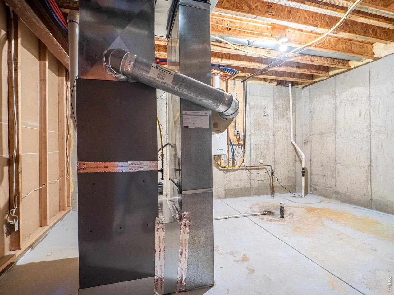 Property Photo 48 Utility room with tankless water heater, furnace, whole house humidifier, and radon mitigation system. Plenty of space for storage.