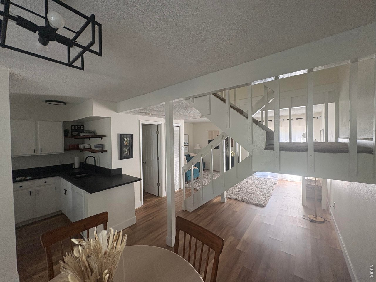 Property Photo 2 Open floor plan with LVP flooring throughout main level with updated light fixtures.