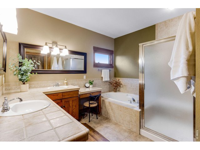 Property Photo 28 5 piece primary bathroom, Jetted spa tub, newly tiled floors and walk-in closet.