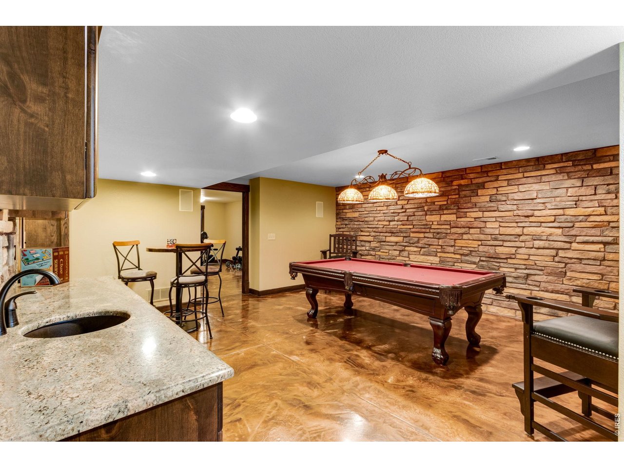 Property Photo 38 Highcraft Basement Remodel, epoxy floors, stone and alder - gorgeous finish. Game room and wet bar area, pool table included. Granite and Stone Wet bar.