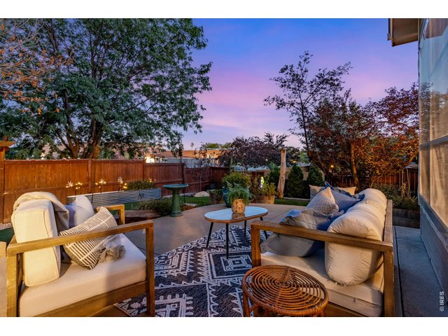 Property Photo 5 Welcome this to private Outdoor Retreat! Nearly 600 SQFT of outdoor living on this massive custom patio. Privacy fence all around, north side Shed and gate right to the trail!