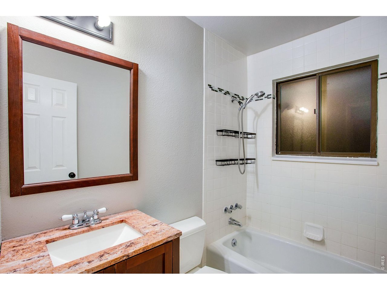 Property Photo 26 Remodeled full bath features tile flooring and granite slab countertop