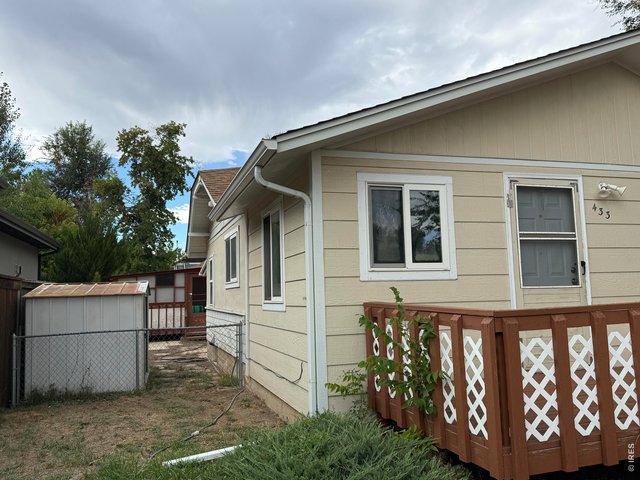 Property Photo 23 South side view of home. Storage shed & fenced area.