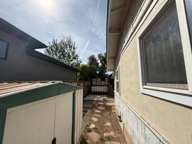 Property Photo 24 Path along south side of the home. Notice the enclosed patio