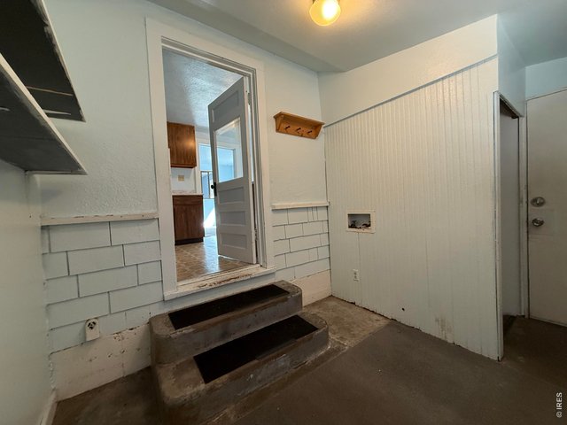 Property Photo 17 Back porch is enclosed and features convenient washer and dryer hookups.