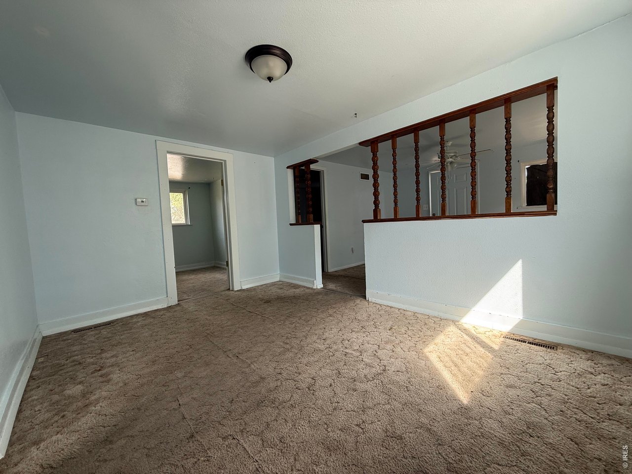 Property Photo 11 Dining Room, with view back to the Living Room and doorway to the Bedroom 1, which includes a full bath