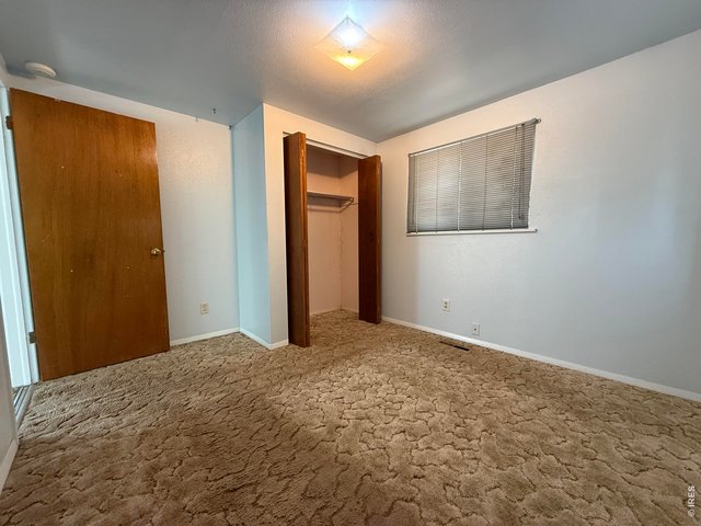 Property Photo 9 Bedroom 2- view of closet