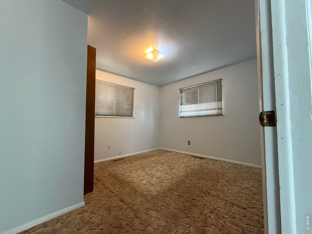 Property Photo 8 Bedroom 2- directly to the right of the Living Room