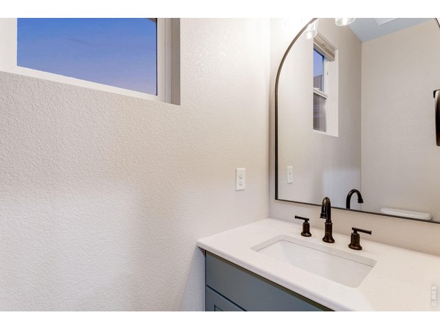 Property Photo 20 bath off garage features a comfort height toilet with soft close lid plus a vanity with quartz countertop