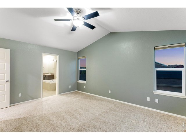 Property Photo 21 Primary bedroom with retreat features a vaulted ceiling, fan,