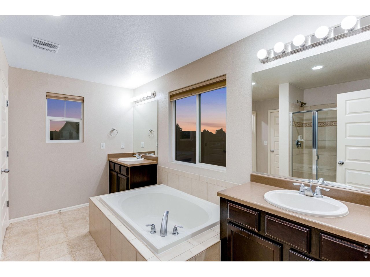 Property Photo 24 5-piece luxury bath with soaking tub, split lifted vanities, shower with sitting bench, door to throne, 2nd linen closet plus a huge walk-in closet with attic access and window