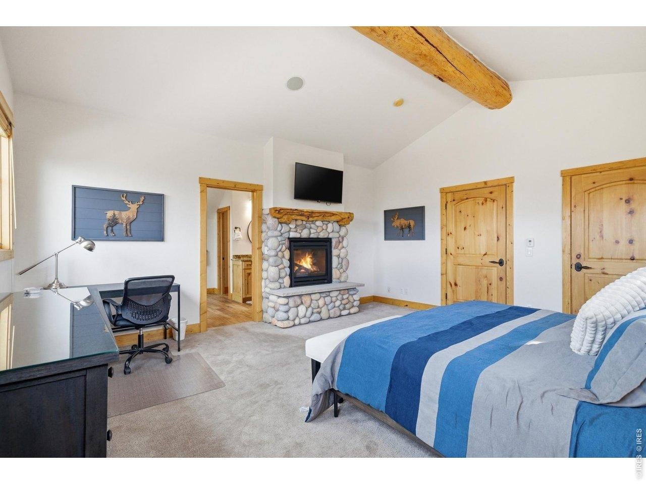 Property Photo 23 Dual sided fireplace in primary bedroom and bathroom with a huge walk in closet
