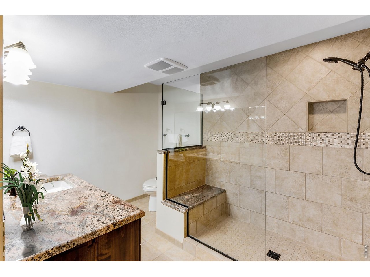 Property Photo 41 Finished Lower Level ensuite bathroom! Spacious with Stunning appointments, Slab Granite countertops, could be a "secondary" primary suite with comfortable heated floors!