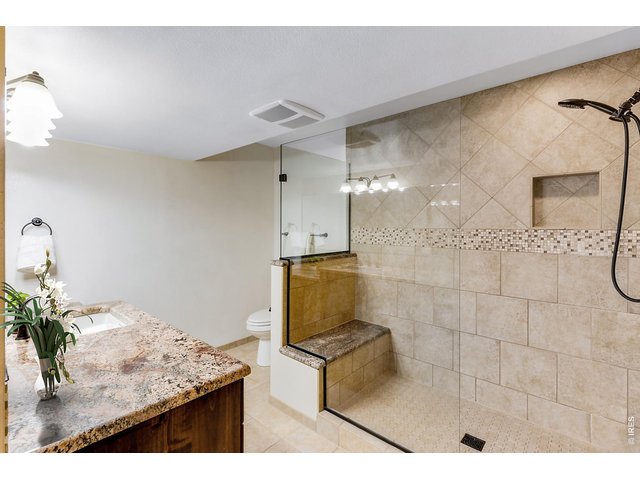 Property Photo 41 Finished Lower Level ensuite bathroom! Spacious with Stunning appointments, Slab Granite countertops, could be a "secondary" primary suite with comfortable heated floors!
