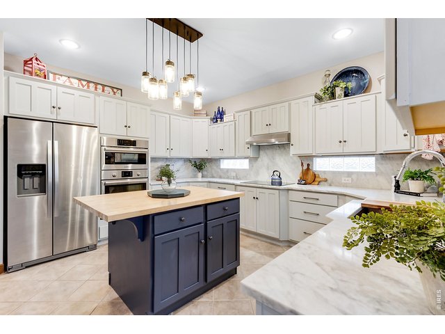 Property Photo 21 All stainless steel appliances, Bosch double wall ovens (top one converts to a microwave) 5 burner cooktop and hood, loaded with shaker cabinetry. Large single basin sink.