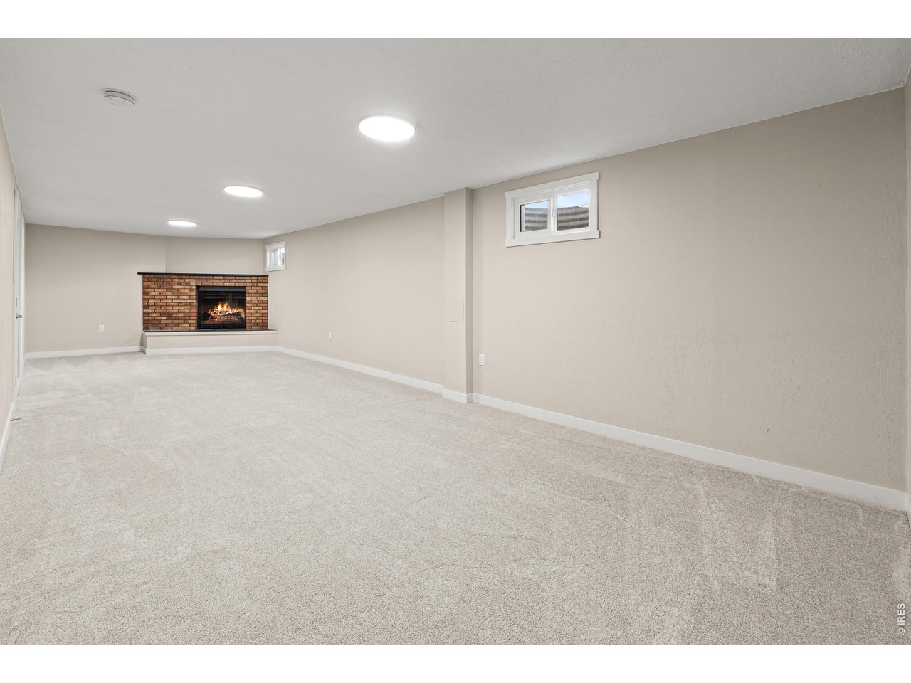 Property Photo 22 Basement rec room w/ wood burning fireplace