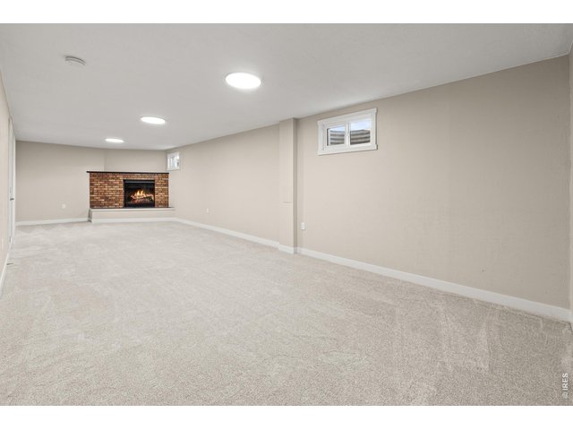 Property Photo 22 Basement rec room w/ wood burning fireplace