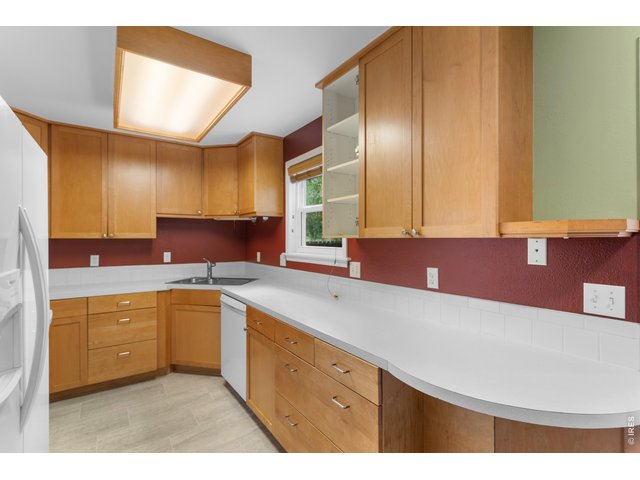 Property Photo 12 Kitchen overlooking the large porch (cabinet door being repaired, will be reinstalled)