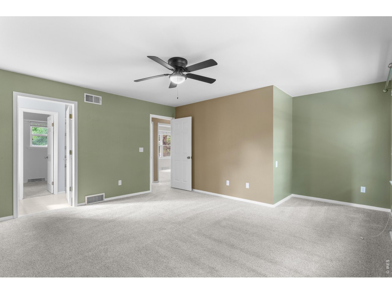 Property Photo 15 Primary with entry to ensuite bathroom (left) and Hallway (middle)