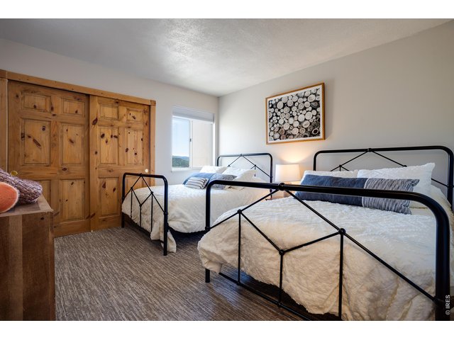 Property Photo 24 Second bedroom with two full beds and extra linens