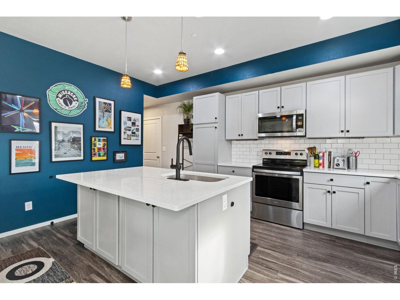 Property Photo 12 The kitchen presents quartz island and countertops, subway tile backsplash, SS appliances included.