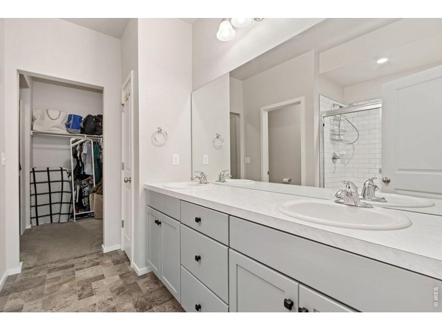 Property Photo 19 Private primary bathroom with double sink vanity, large shower and walk in closet.