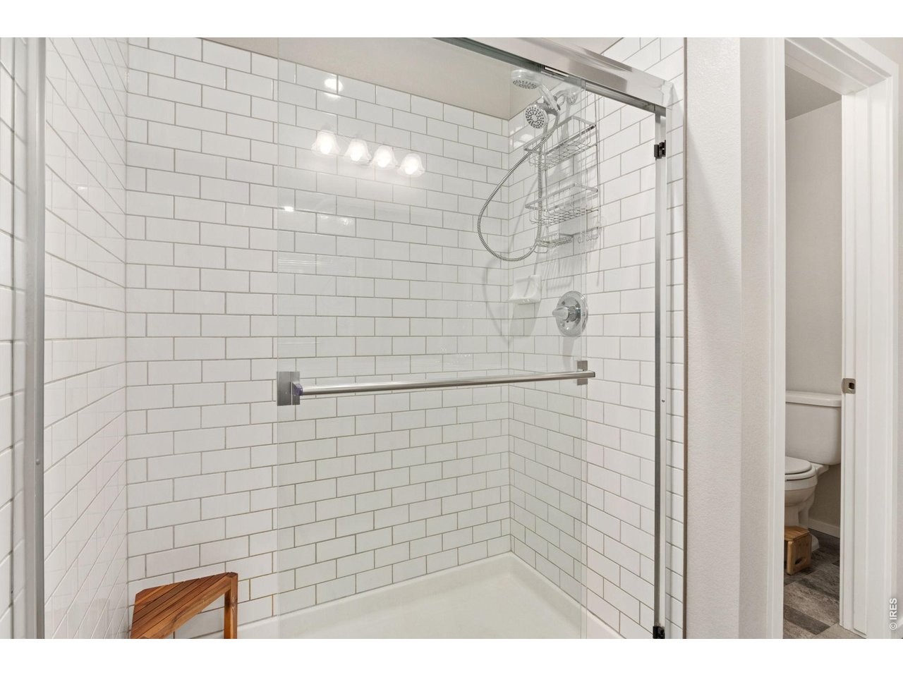 Property Photo 20 Subway tiled shower at the primary bathroom.