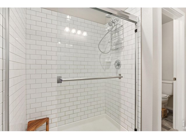 Property Photo 20 Subway tiled shower at the primary bathroom.
