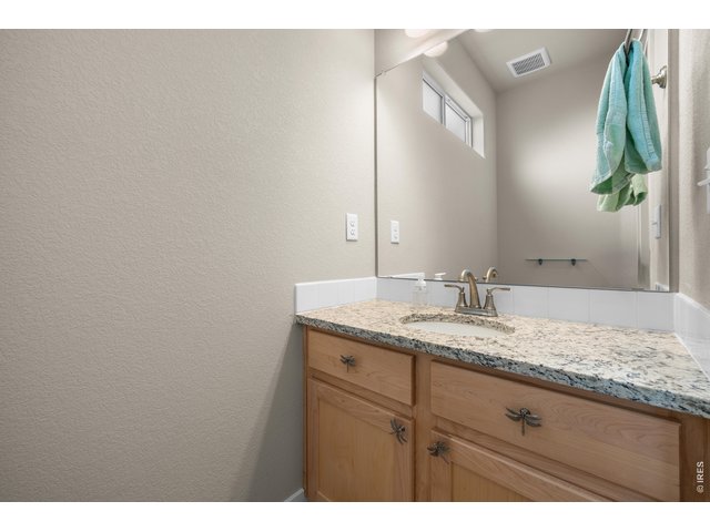 Property Photo 14 Main Floor Half Bathroom with White Granite Countertop.