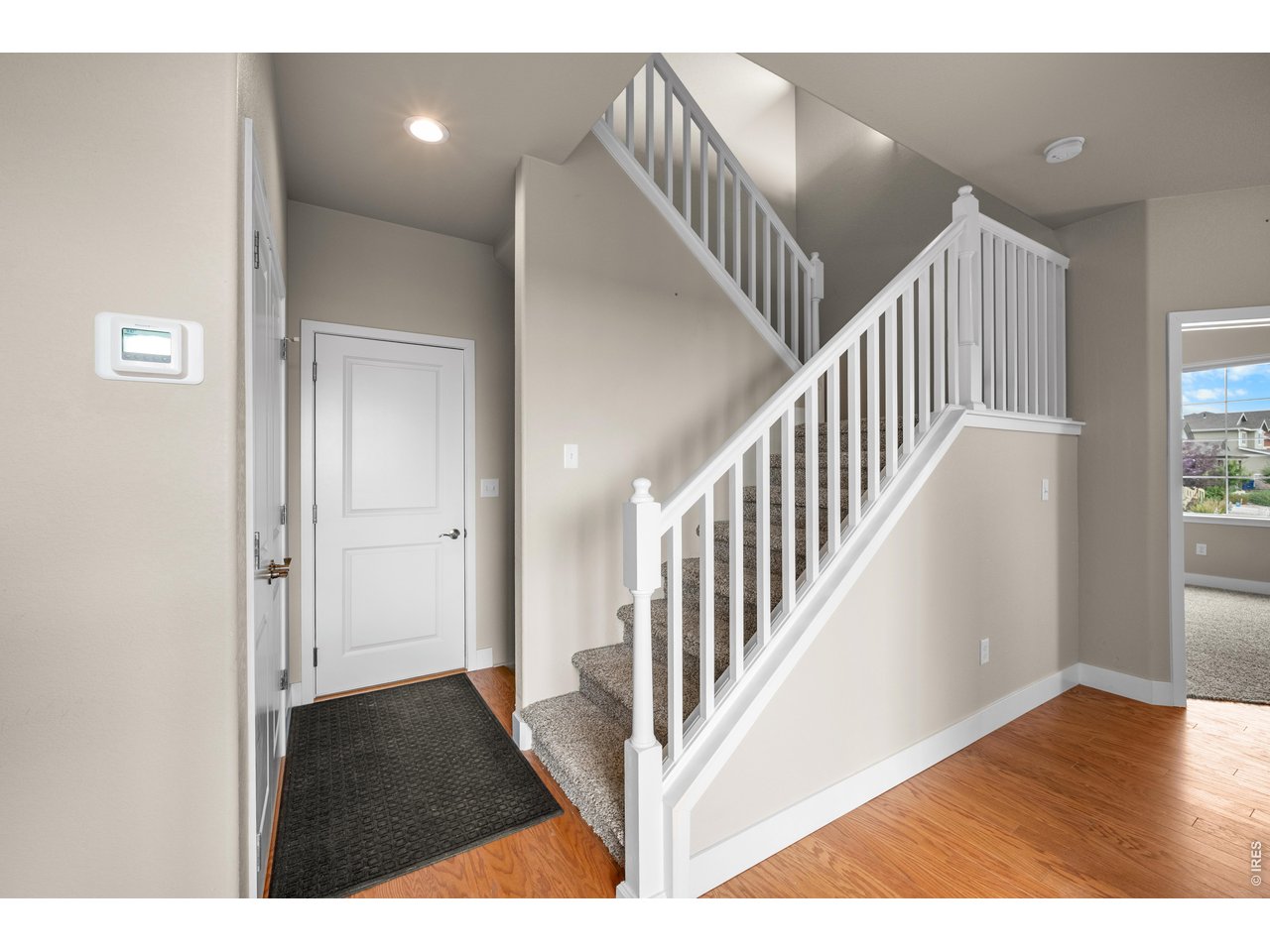 Property Photo 15 Garage Entry Door that is close to the Kitchen and Stairs leading to the Upper Level.