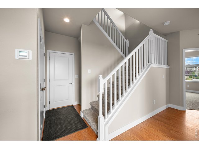 Property Photo 15 Garage Entry Door that is close to the Kitchen and Stairs leading to the Upper Level.