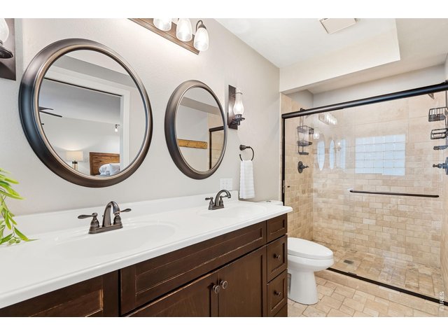 Property Photo 30 Primary bath with double vanities and walk-in shower with two heads.