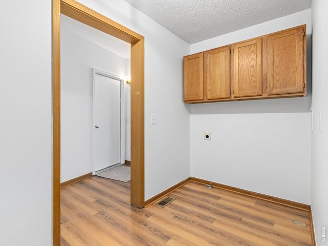 Property Photo 32 Laundry area with storage and new flooring