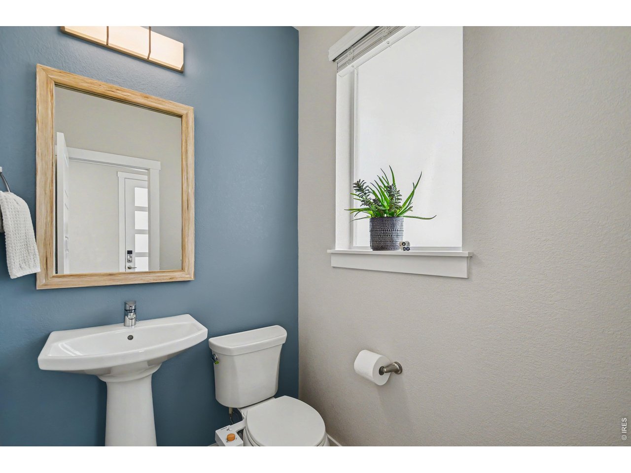 Property Photo 7 Powder bath on main level with framed mirror