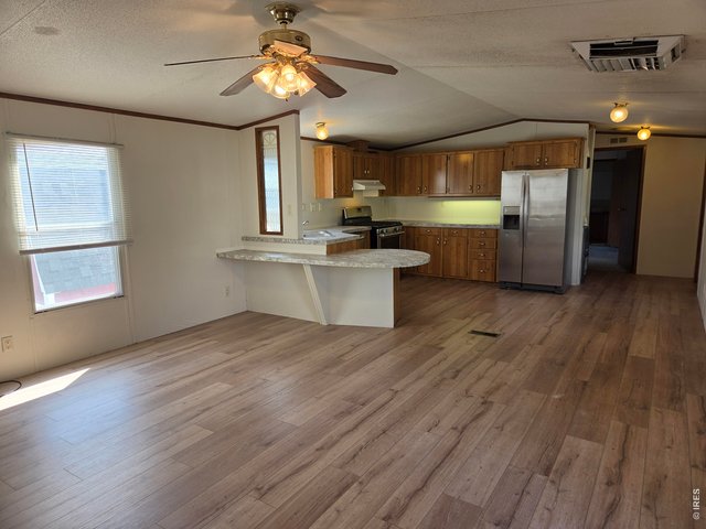 Property Photo 5 Living room looking into kitchen