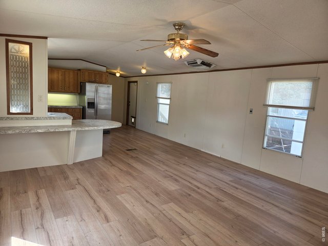 Property Photo 4 Living room looking into Kitchen